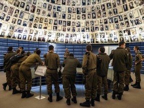 Israeli soldiers visit the Hall of Names at the Yad Vashem Holocaust Memorial museum in Jerusalem, Thursday, Jan. 26, 2023, a day ahead of the International Holocaust Remembrance Day.