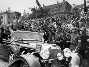 Undated photo taken from 1937 shows German Chancellor Adolf Hitler standing in a convertible Mercedes reviewing SA and SS troops and wellwishers somewhere in Germany.