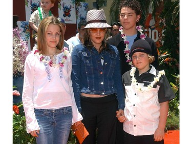 In this file photo taken on July 16, 2002 Lisa Marie Presley and her children Benjamin Keough (right),  Riley Keough (left), and her half-brother Navarone Garibaldi (back) attend the premiere of "Lilo and Stitch" at the El Capitan theatre in Hollywood.