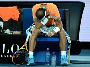 Spain's Rafael Nadal takes rest during the break in his men's singles match against Mackenzie McDonald of the US on day three of the Australian Open tennis tournament in Melbourne on January 18, 2023.