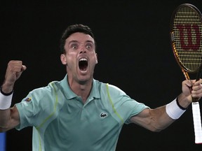 Roberto Bautista Agut of Spain celebrates after defeating Andy Murray of Britain in their third round match at the Australian Open tennis championship in Melbourne, Australia, Saturday, Jan. 21, 2023.