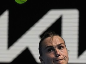 Aryna Sabalenka of Belarus plays a backhand return to Tereza Martincova of the Czech Republic during their first round match at the Australian Open tennis championship in Melbourne, Australia, Tuesday, Jan. 17, 2023.