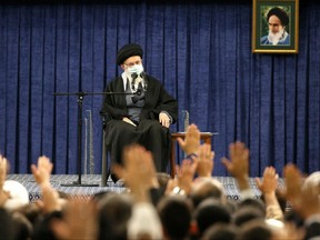 This handout picture provided by the office of Iran's Supreme Leader Ayatollah Ali Khamenei shows him giving an address before visitors from the city of Qom in the capital Tehran on Jan. 9, 2023.