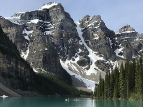 Paddle boarders are seen on Moraine Lake in Lake Louise, Alta., in June 2020.