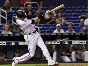 Miami Marlins right fielder Brian Anderson  hits a solo home run in the fifth inning against the Arizona Diamondbacks at Marlins Park.