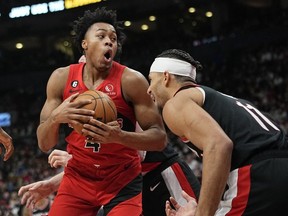 Toronto Raptors forward Scottie Barnes comes down with a rebound against Portland Trail Blazers guard Josh Hart during the second half at Scotiabank Arena.