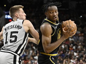 Golden State Warriors' Jonathan Kuminga drives against San Antonio Spurs' Joe Wieskamp during the first half of an NBA basketball game on Saturday, April 9, 2022, in San Antonio. The Toronto Raptors have signed Wieskamp to a second 10-day contract.