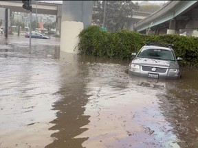 Cars are seen partially submerged on a flooded road after heavy rains in San Francisco, Calif., Dec. 31, 2022, in this screengrab obtained from a social media video.
