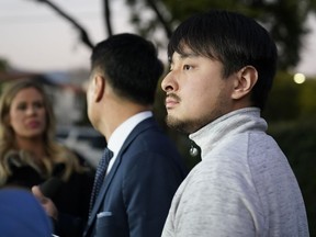 Brandon Tsay, 26, right, and his father, Tom Tsay, make a statement outside their home on Monday, Jan. 23, 2023, in San Marino, Calif.