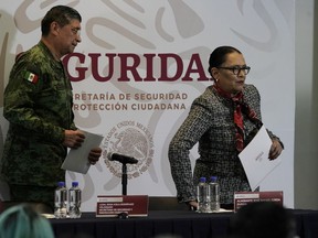 Mexican Public Safety Secretary Rosa Icela Rodriguez, right, and Mexican Defence Secretary Luis Cresencio Sandoval leave after a news conference announcing the arrest of Ovidio Guzman in Mexico City, Jan. 5, 2023.