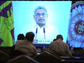Participants look at Sri Lankan President Gotabaya Rajapaksa's pre-recorded speech shown on a screen at a session of the International Conference on "The Future of Asia" Thursday, May 26, 2022 in Tokyo.