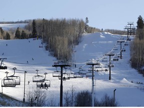 People ski and ride the lift at the Park City Mountain Resort in Park City, Utah, on Friday, Jan. 13, 2012.