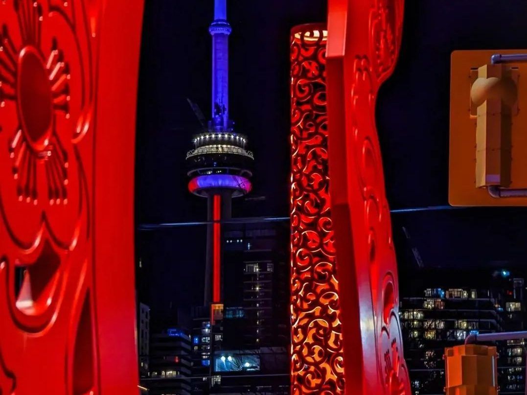 View of CN Tower from Huron Square at night.