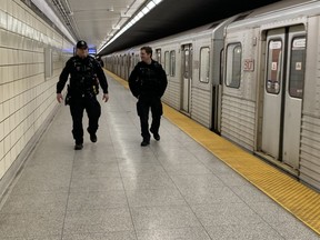 Toronto Police Consts. Greg Henkenhaf and Dave Donaldson on patrol at Spadina TTC station on Thursday, Jan. 26, 2023.