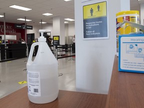 Hand sanitizer, face masks and wipes are available at the entrance of a Service Canada office Tuesday July 7, 2020 in Gatineau, Que.