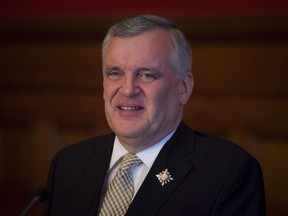 Former Ontario lieutenant-governor David Onley laughs while speaking with reporters on his final full day in office at Queen’s Park in Toronto on Monday, Sept. 22, 2014.