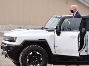 U.S. President Joe Biden test drives a GMC Hummer EV as he tours the General Motors Factory ZERO electric vehicle assembly plant in Detroit, Mich., on Nov. 17, 2021.
