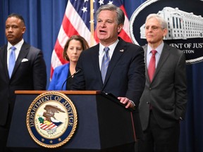 FBI Director Christopher Wray with Deputy Attorney General Lisa Monaco (second from left), and U.S. Attorney General Merrick Garland (right), speaks during a press conference to announce an international ransomware enforcement action, at the Justice Department in Washington, D.C., on Jan. 26, 2023.