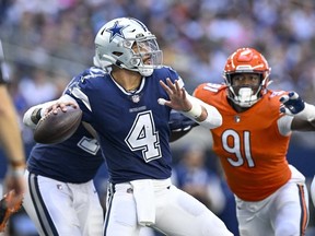 Dallas Cowboys quarterback Dak Prescott and Chicago Bears defensive end Dominique Robinson in action during the game between the Dallas Cowboys and the Chicago Bears at AT&T Stadium.