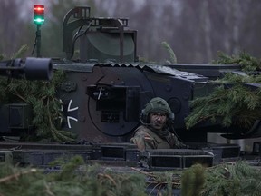 A crew member sits in a Puma infantry fighting vehicle of Panzergrenadierbataillon 122, a mechanized infantry unit of the Bundeswehr, the German armed forces, during a visit by German Defence Minister Boris Pistorius at Altengrabow on January 26, 2023 near Moeckern, Germany.