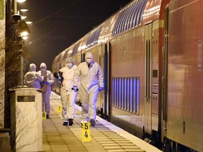 Forensic staff of the police secures and photographs evidence on the platform of the train station in Brokstedt on January 25, 2023, after two people were killed and several others wounded in a knife attack on a regional train between the cities of Hamburg and Kiel.