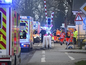 Police and rescue services are on duty at a level crossing near Brokstedt station in Brockstedt, Germany, Wednesday, Jan. 25, 2023.