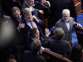 Mike D. Rogers (R-Ala.) is restrained after getting into an argument with Matt Gaetz (R-Fla.) during the 14th round of voting for House speaker on Friday at the U.S. Capitol in Washington.
