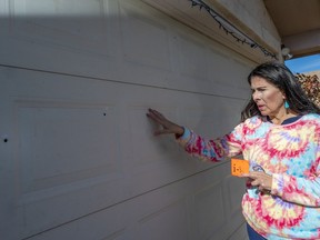 Sen. Linda Lopez , D-Albuquerque, shows bullet holes in her garage door after her Westside home was shot at last month on Thursday Jan. 5 , 2023 in Albuquerque, N.M.