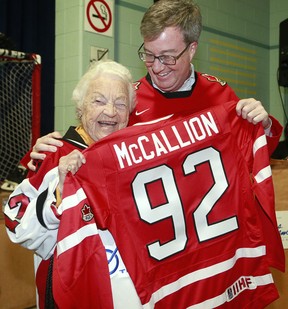 Ottawa Mayor Jim Watson gives Mississauga Mayor Hazel McCallion a hockey sweater for all her work on behalf of women's hockey over the years, ahead of the IIHF Ice Hockey Women's World Championship, in Ottawa, March 28, 2013. (Julie Oliver/Ottawa Citizen)