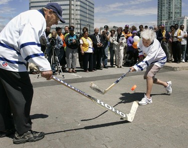 Mississauga Mayor Hazel McCallion took some shots against Maple Leafs goalie great Johnny Bower in a game of ball hockey after announcing Mississauga's city centre is about to be transformed into a unique "outdoor community centre". (Michael Peake/Toronto Sun)