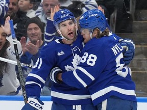Toronto Maple Leafs right wing William Nylander celebrates his goal against the New York Islanders with teammate John Tavares during second period NHL hockey action in Toronto on Monday Jan. 23, 2023.