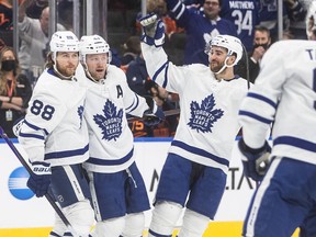 Toronto Maple Leafs' William Nylander (88), Morgan Rielly (44) and T.J. Brodie (78) celebrate a goal against the Edmonton Oilers during third period NHL action in Edmonton on Tuesday, December 14, 2021.