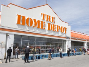 A line up of customers outside a Home Depot in Ottawa wait to enter the store.