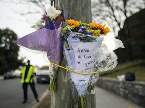 Flowers are secured to a pole as a memorial to Karon Blake, 13, on the corner of Quincy Street NE and Michigan Avenue NE in the Brookland neighborhood of Washington, Tuesday, Jan. 10, 2023. The note reads, "Karon we will love and miss you dearly." Karon Blake was shot and killed on the 1000 block of Quincy Street NE early morning Saturday, Jan. 7, 2023.