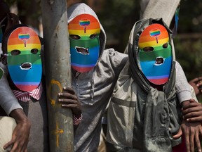 Kenyan members and supporters of the LGTB community wear masks to preserve their anonymity as they stage a protest in Nairobi, Kenya, Monday, Feb. 10, 2014.