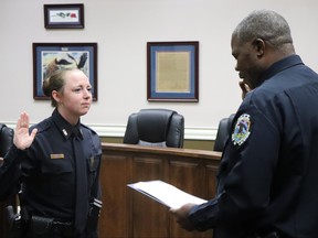 Young female officer being sworn in.