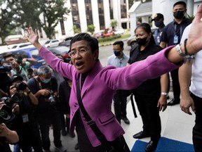 Rappler CEO and Nobel Laureate Maria Ressa gestures after a Manila court acquitted her from a tax evasion case, outside the Court of Tax Appeals in Quezon City, Philippines, Jan. 18, 2023.