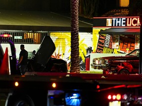 Bullet holes and broken glass are seen on a car being towed from the restaurant "The Licking" where a shooting investigation is being held in Miami Gardens, Florida on January 5, 2023.
