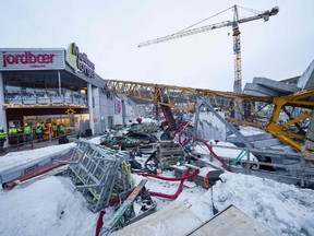 Photo taken on January 6, 2023 shows a 50-metre-high crane that has toppled over the Melhustorget shopping centre in Melhus, Norway.