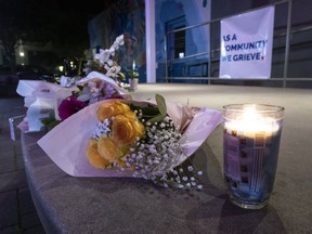 Flowers and candles lie at a memorial for victims of the mass shooting a day earlier, in Half Moon Bay, Calif., Tuesday, Jan.  24, 2023.