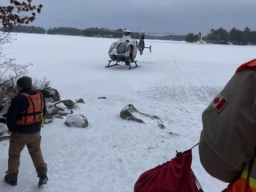 An OPP helicopter lands at the scene of a rescue on Six Mile Lake in southern Ontario, Sunday January 22, 2023. The body of a snowmobiler who had been missing on a southern Ontario lake has been recovered by divers.