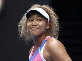 Naomi Osaka of Japan smiles during her first round match against Camila Osorio of Colombia at the Australian Open tennis championships in Melbourne, Australia, Monday, Jan. 17, 2022.