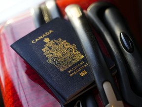 A Canadian passport sits on a suitcase in Ottawa on Tuesday, Jan. 17, 2023.