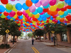 A balloon art installation, part of the annual Foo Foo Fest, covers a street in Pensacola.
