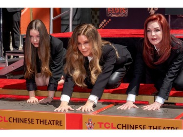 Priscilla Presley, Lisa Marie Presley and Riley Keough, place their handprints in cement at TCL Chinese theatre in Los Angeles, Calif., June 21, 2022.