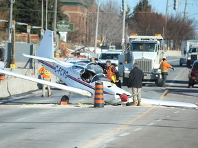 A Slingsby T67C single-engine single seat plane lays crumpled onto 16th Ave. east of Hwy. 404 just before after noon on Monday, Jan. 16, 2023.