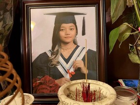 Handout photo of shrine and graduation photo for Ebus victim Kathy Kim Le. Kathy, 18, is one of four passengers that were killed when the westbound bus carrying 46 people, including the driver, rolled over at about 6 p.m. on Christmas Eve. Photo credit: Kevin Pham.