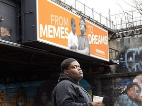Dieunerst Collin, famous for Popeyes meme when he was 9, inks deal with Popeyes, new billboard in the background.