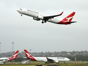 This file photo taken on May 6, 2021 shows a Qantas plane taking off from the Sydney International airport in Sydney.