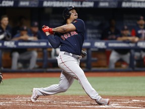 Boston Red Sox's Rafael Devers watches his RBI-single against the Tampa Bay Rays during the third inning of a baseball game Monday, Sept. 5, 2022, in St. Petersburg, Fla.
